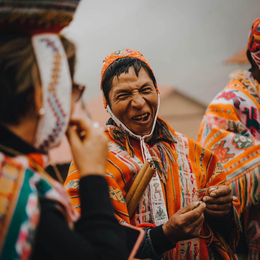 pexels-photo-17060523-17060523 A man in vibrant traditional clothing shares a joyful moment outdoors.